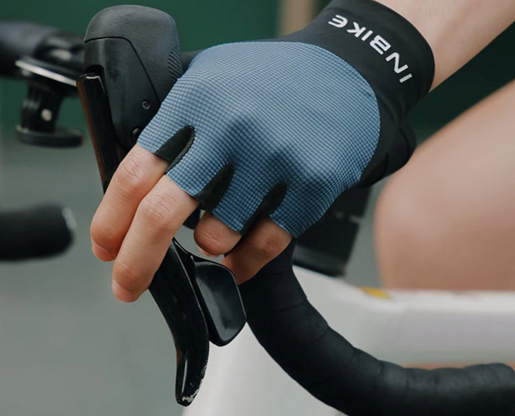 Person wearing a blue cycling glove on a blurred background