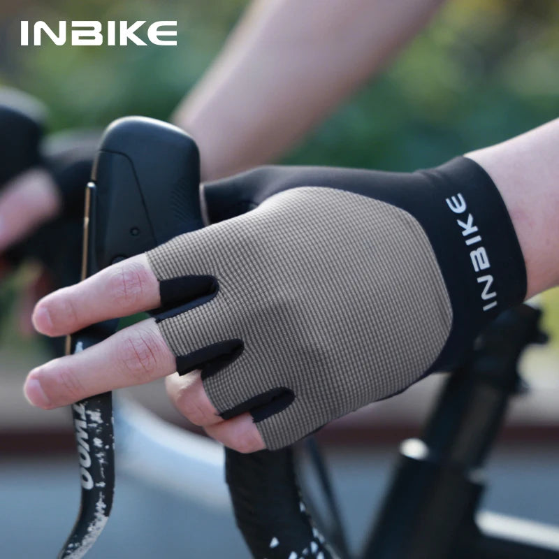 Person wearing a brown cycling glove with 'INBIKE' branding on a blurred background
