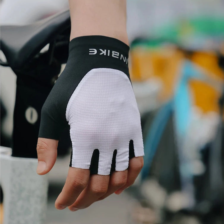 Black and white glove with 'INBIKE' branding held by a person, blurred background