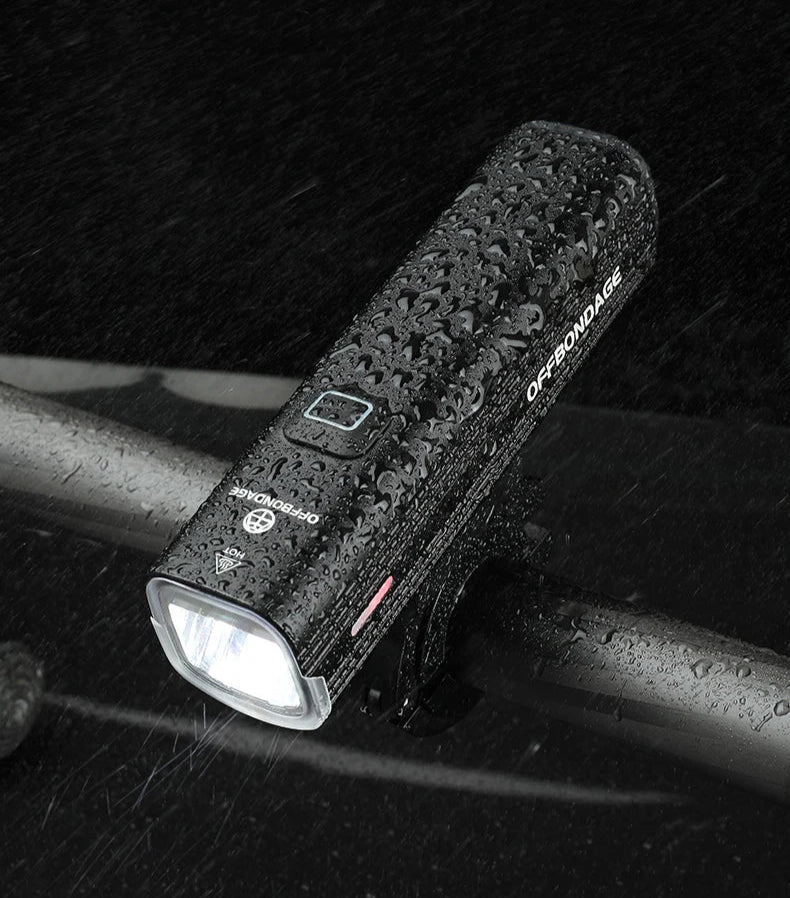 Bicycle lamp on a bike handlebar with text about weather resistance and waterproofing.