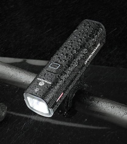 Bicycle lamp on a bike handlebar with text about weather resistance and waterproofing.