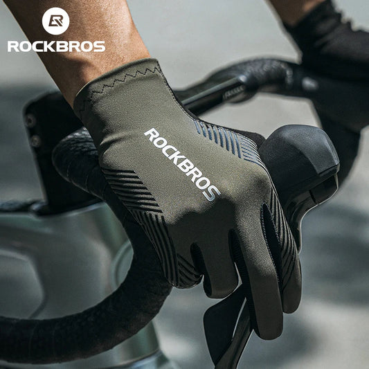 Person wearing a green 'RockBros' glove holding a bike handlebar.
